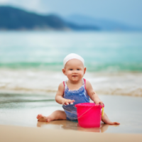 little baby play on ocean deep